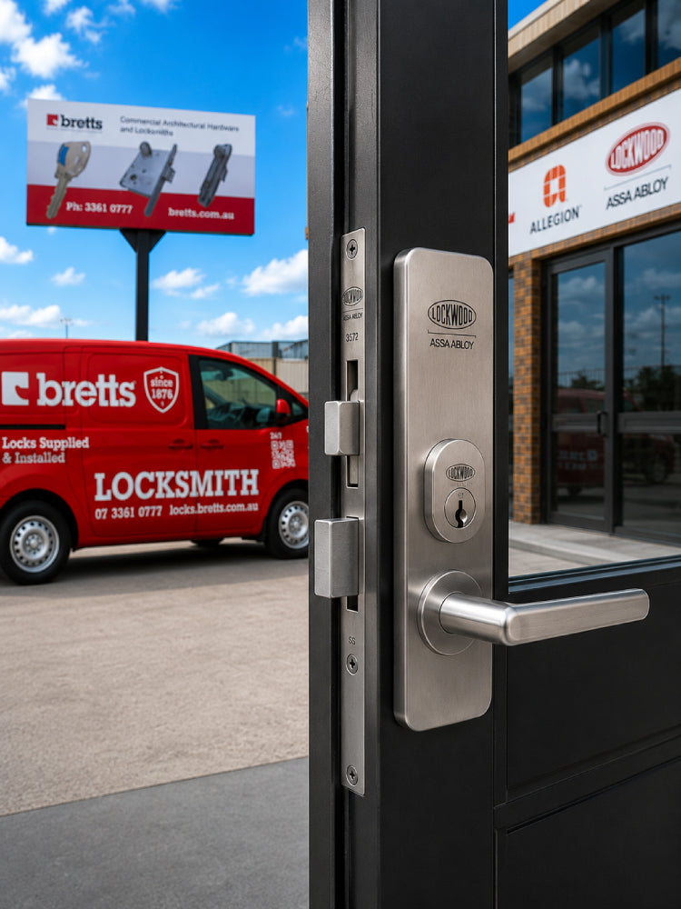 Locksmith van parked outside a building with a focus on a door handle and lock.